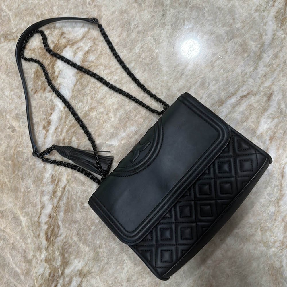 Tory Burch black leather.  Chain is also monochrome black.